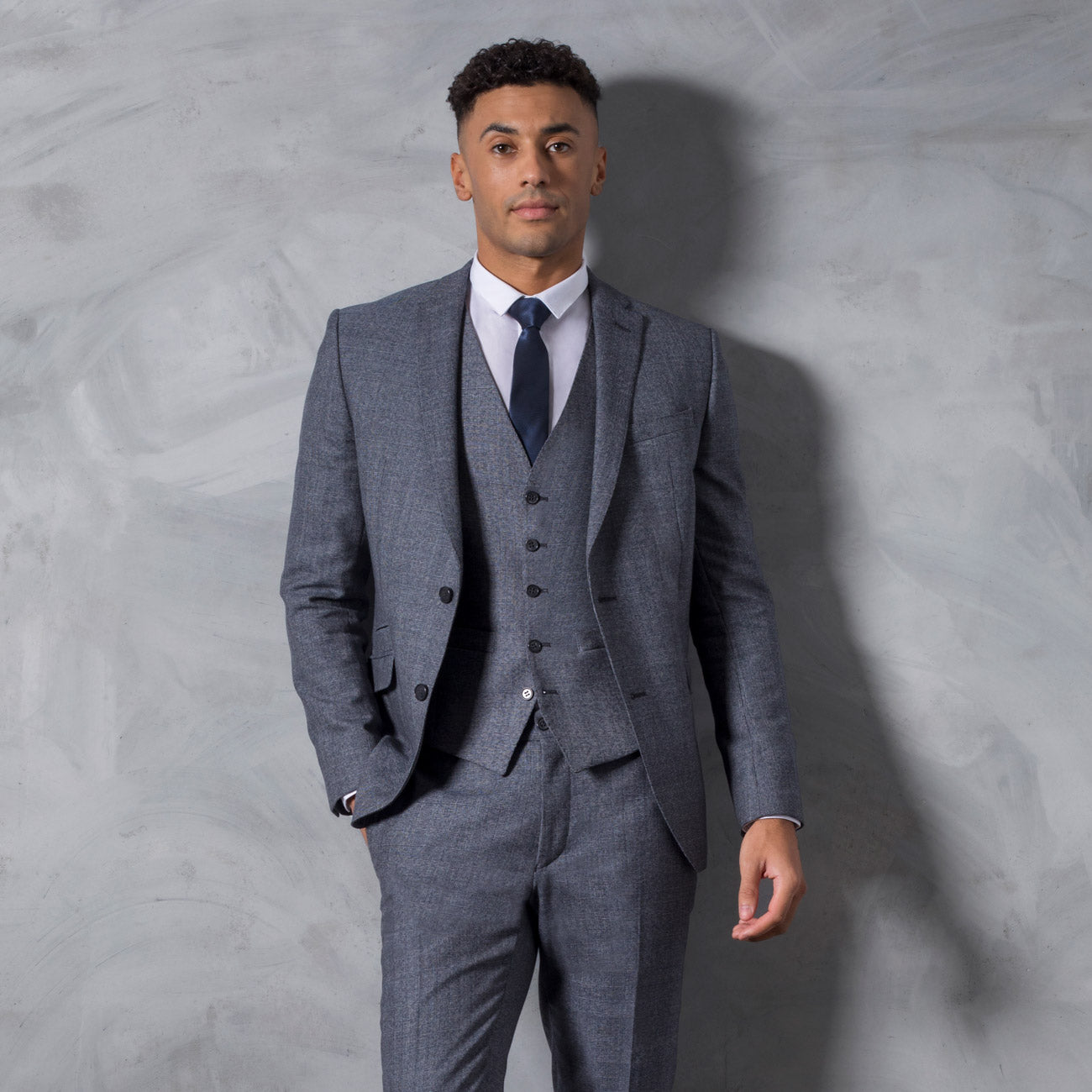 In its cool, calm and collected grey-blue, The Minster is unflappable, and quite literally so, when you factor in its modern and stylish slim-fit cut. The Prince of Wales check gives a subtly regal look to this three piece suit.
