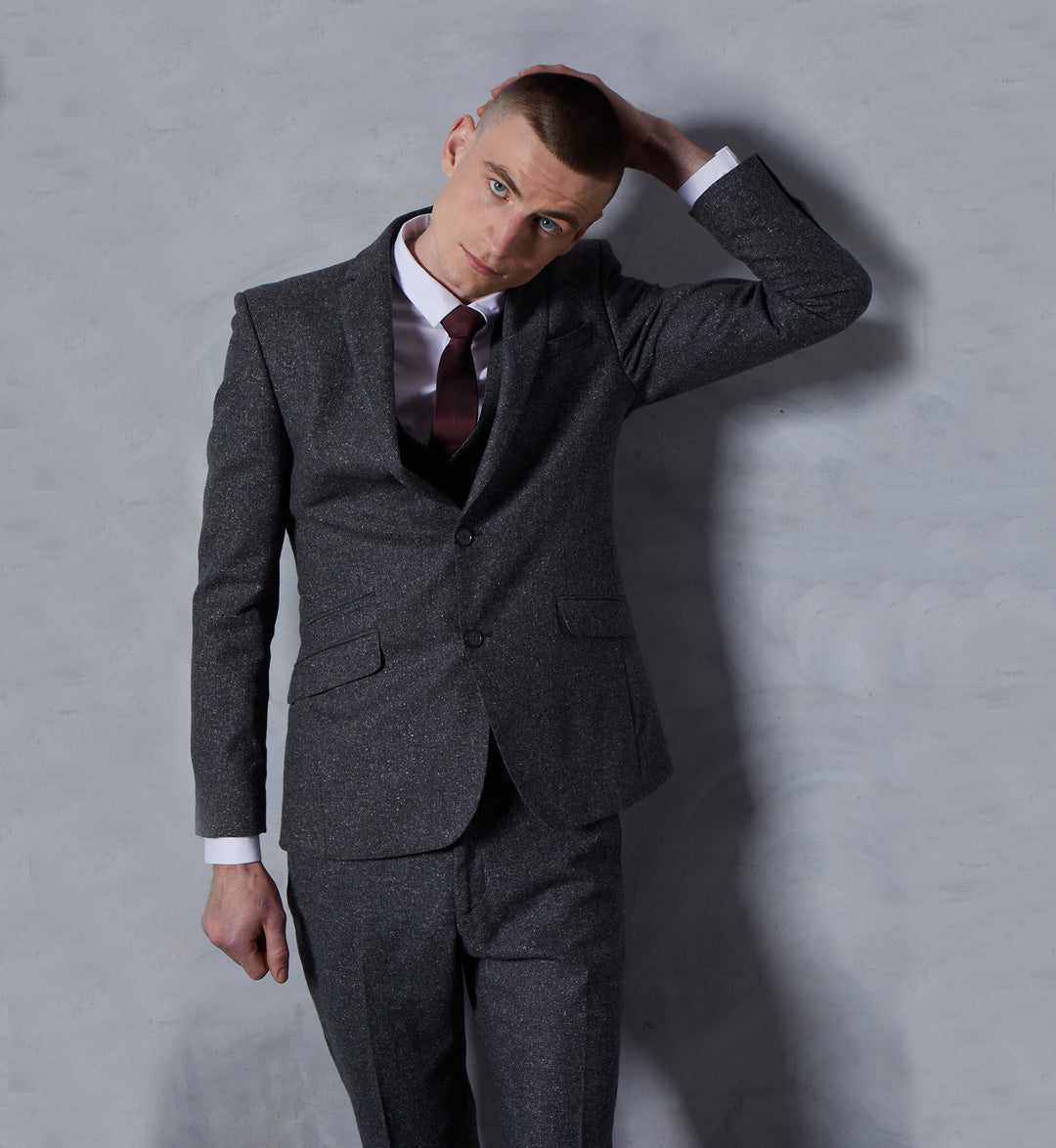 With a look all of its own in grey fleck tweed, the Shibden suit on the homepage of the Tom Percy website is the outlier of the Holmfield heritage men's three piece suit collection. The traditional dark gray color pairs well with anything.